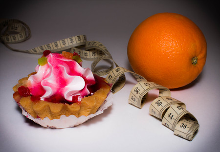 cupcake, centimeter and orange on a light background, sweet or fruit for dietの写真素材