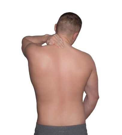 pain in the upper spine, a man holding his hand on his neckの写真素材
