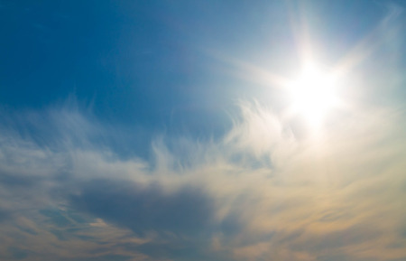 The morning sun over a white cloudの写真素材