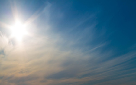 The morning sun over a white cloudの写真素材