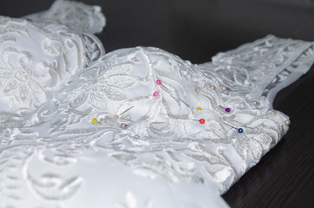 Sewing the wedding dress, needle in the fabric patternの写真素材