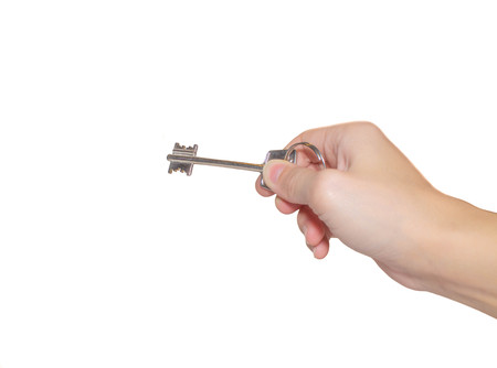 key in hand on white isolated backgroundの写真素材