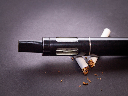 anti-smoking concept, vaporizer lies on cigaretteの写真素材