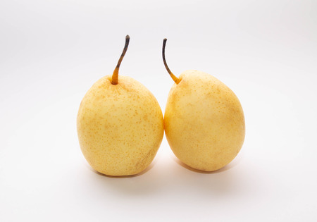 two yellow pears on a blue and white backgroundの写真素材