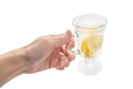 mug in female hand on white isolated backgroundの写真素材