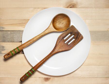wooden spoon and paddle on light table backgroundの写真素材
