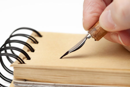 Making notes into pad with pen point isolated white background macro