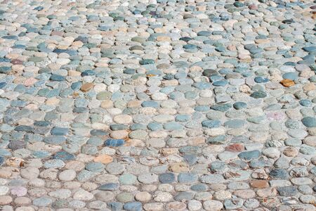 Colorful paved road with little different colors round stonesの写真素材