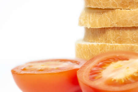 Stack sliced bread with tomatoes isolated macro on white backgroundの写真素材