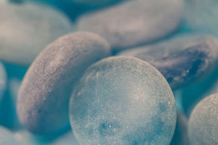 Polished smooth glass blue round stones macroの写真素材