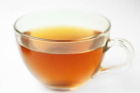 Glass of tea in transparent cup with morning lights bokeh macroの写真素材