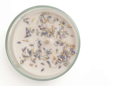 Aromatized candle with little lavanda dry flowers above view isolated on white backgroundの写真素材