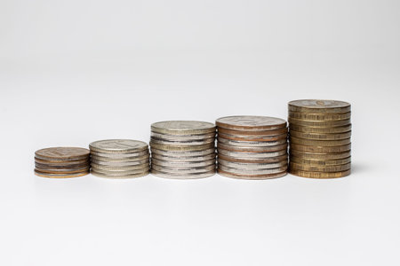 Five stack of coins isolated on white background