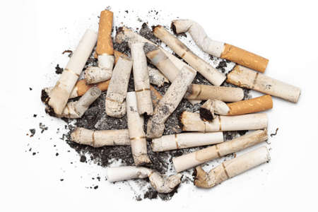 Bunch used cigarettes isolated white background macroの写真素材