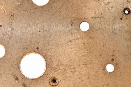 Rusty golden copper old surface with holes for grunge wallpaper or backgroundの写真素材