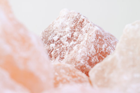 Rose aroma himalayan salt healthy spa cut pink crystals macro with light backgroundの写真素材