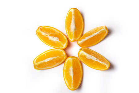 Orange slices ispread out in the form of the sun solated on white background.