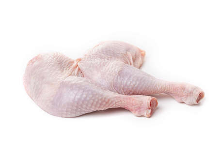 Raw chicken legs with skin on a white background.の写真素材