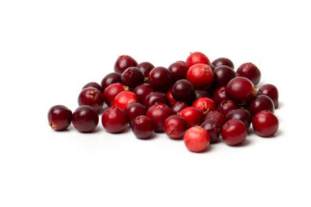 Red cranberry berry with green leaves in a transparent bowl isolated on a white background.の写真素材