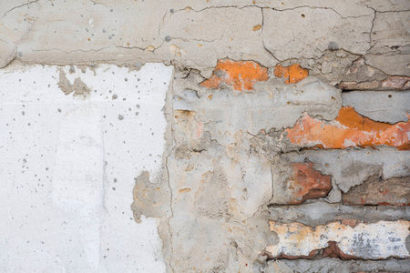 Brick wall with cement mortar and parts of plaster