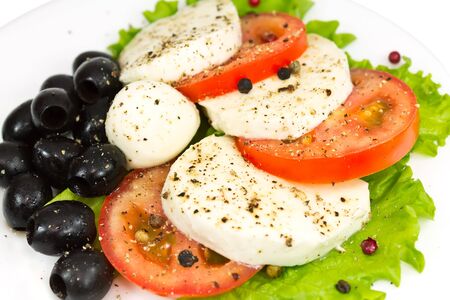 salad of mozzarella, tomatoes, olives and seasoningの写真素材