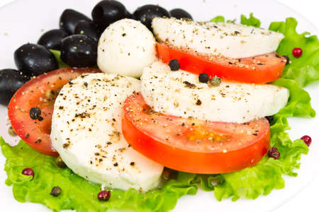 salad of mozzarella, tomatoes, olives and seasoningの写真素材