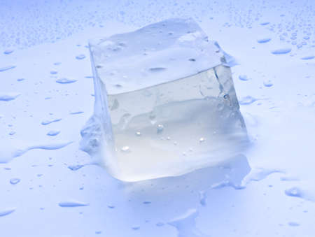 an ice cube with water drops backgroundの写真素材