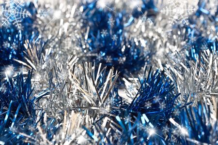Christmas blue background with snowflakes and tinselの写真素材