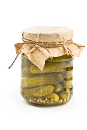 Pickled cucumbers in glass jar isolated on white backgroundの写真素材