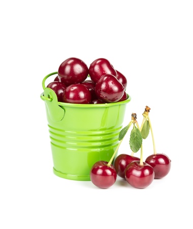 Ripe cherries in a bucket isolated on white backgroundの写真素材