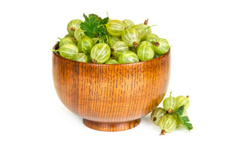 Gooseberries in a wooden bowl isolated on white backgroundの写真素材