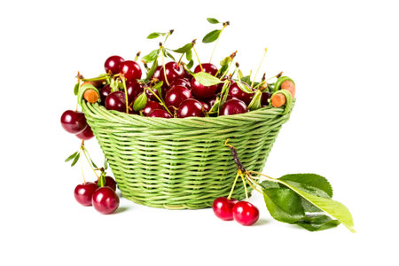 Ripe cherries in wicker basket isolated on white background