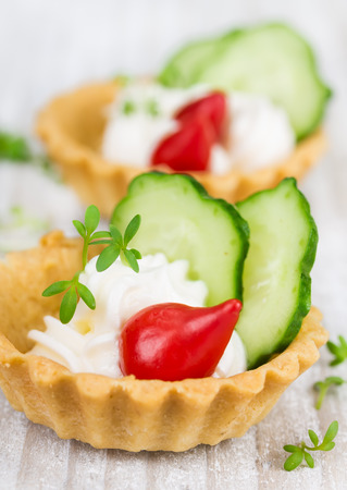 Tartlets with cream, pepper and cucumberの写真素材