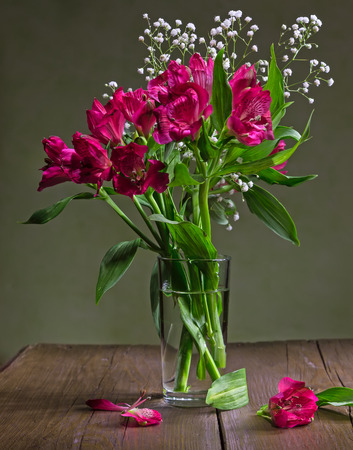 Still life of flowers alstroemeria and camomiles in a glass vase.の写真素材