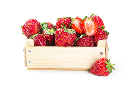 Strawberries in wooden box isolated on white backgroundの写真素材