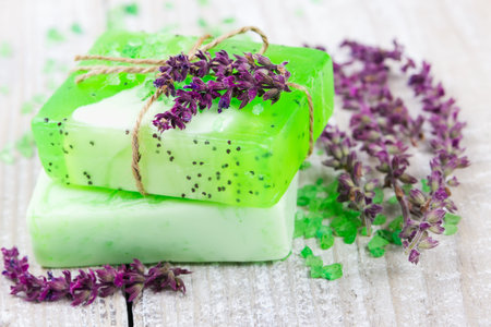 Aroma spa on wooden background with flowers of sage