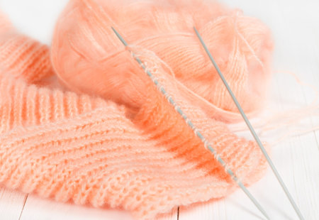 Knitted wool scarf on a wooden background.