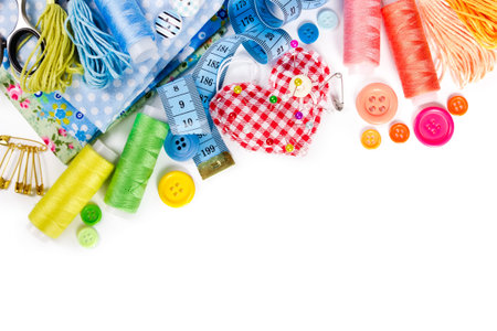 Materials and accessories for sewing - fabric, pins, thread, buttons and measuring tape isolated on...