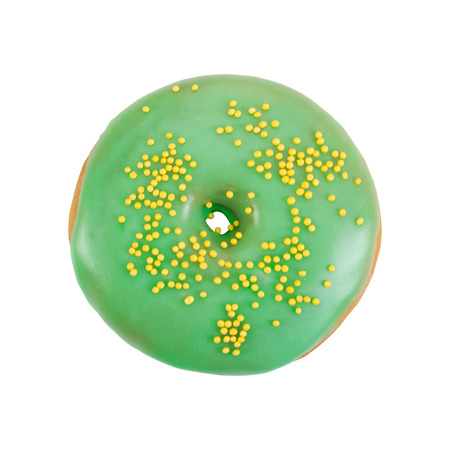 Donut with green glaze and yellow sprinkles isolated on white background. Top view.の写真素材