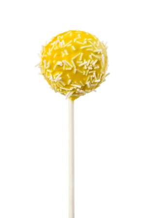 Cake pop in yellow frosting with decorative white sprinkles isolated on white backgroundの写真素材