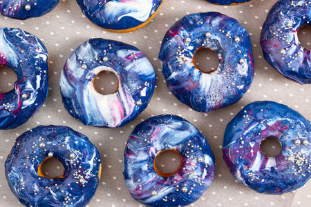 Set of donuts with cosmic icing and silver sprinkles. Top view.の写真素材