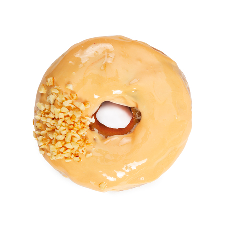 Donut with caramel icing and nuts isolated on white background. Top view.の写真素材