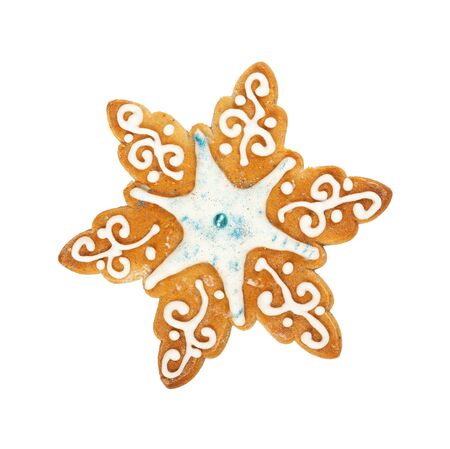Traditional Christmas gingerbread in the shape of snowflake isolated on white background. Top view. Christmas and New Year celebration concept.の写真素材