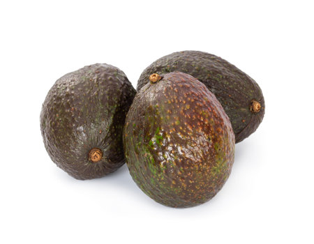 Three avocado hass isolated on white background.
