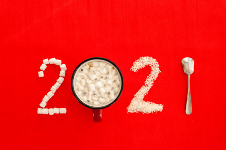 New Years coffee 2021. A mug of coffee or cocoa and a figure 2021 composed of marshmallows and...