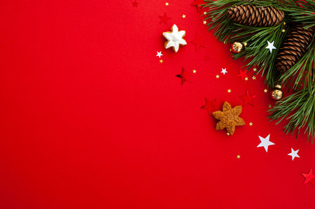 Christmas background. Christmas tree decorated with sparkling stars and balls on a red background....
