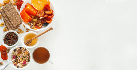 Vegan breakfast with winter fruits, dried fruits, granola and tea. Strengthening the immune system....