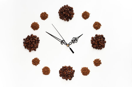 Grain and instant coffee laid out in the form of a clock face on a white background. Love for coffee. Caffeine addiction. Time for coffeeの写真素材