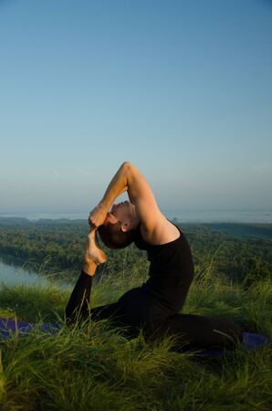 Yoga in the nature: Strength, harmony and tranquilityの写真素材
