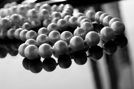 Pearl beads on a glossy surfaceの写真素材